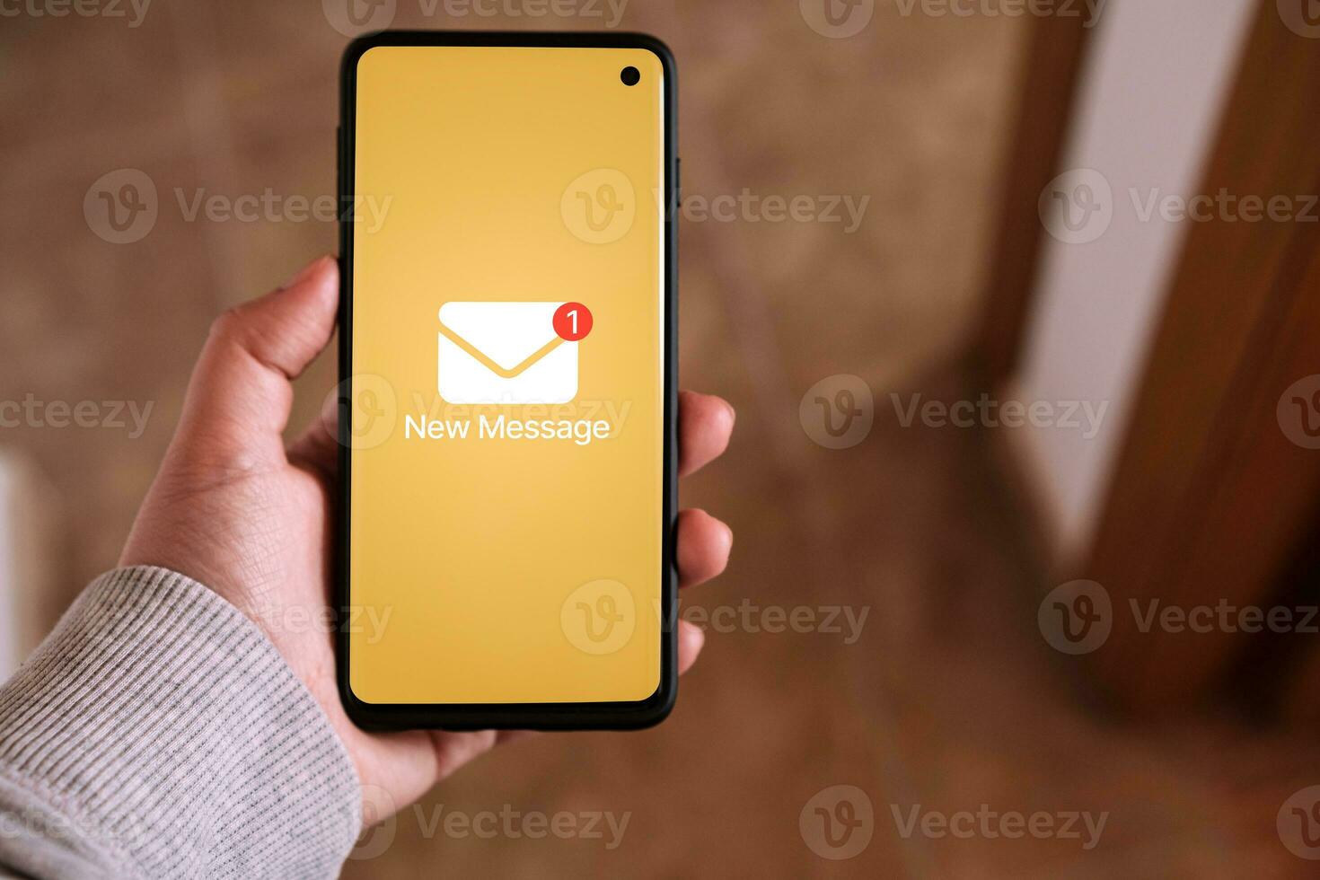 Woman hand holds a smartphone with a new message notification on screen. Communication business technology. Inbox view. New e-mail on mobile smartphone. photo