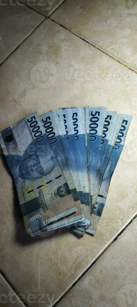 fifty thousand bills neatly arranged on the floor photo