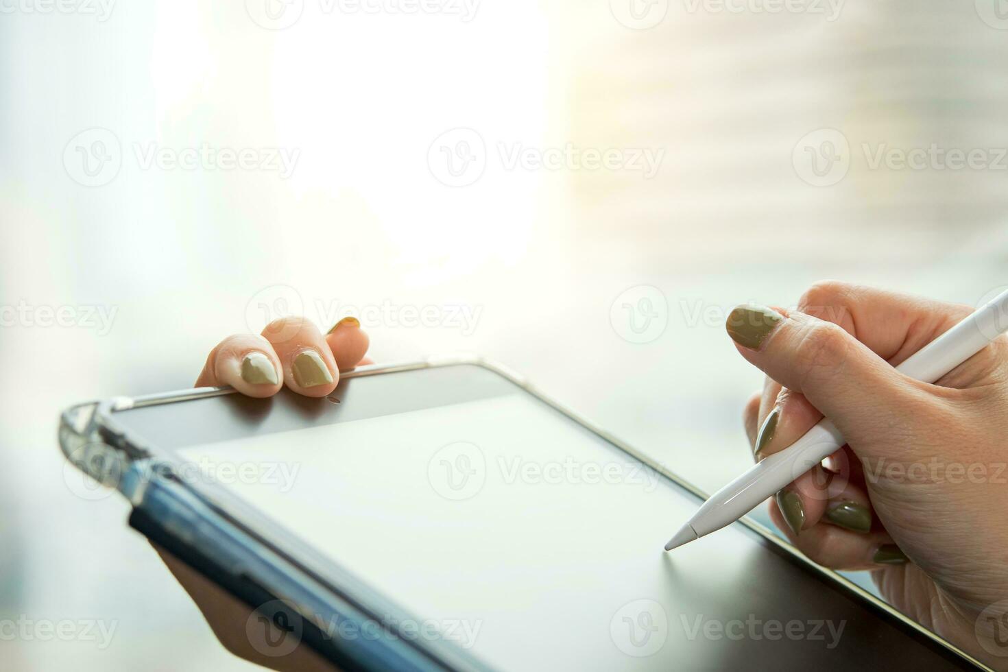 Digital signature, electronic note taking. Close up view of woman holding stylus pen signing electronic documents via digital application in tablet photo