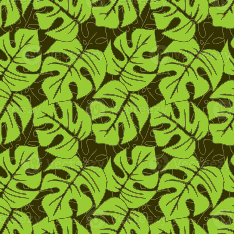 seamless asymmetric pattern of green tropical leaves on a dark green background, texture, design photo