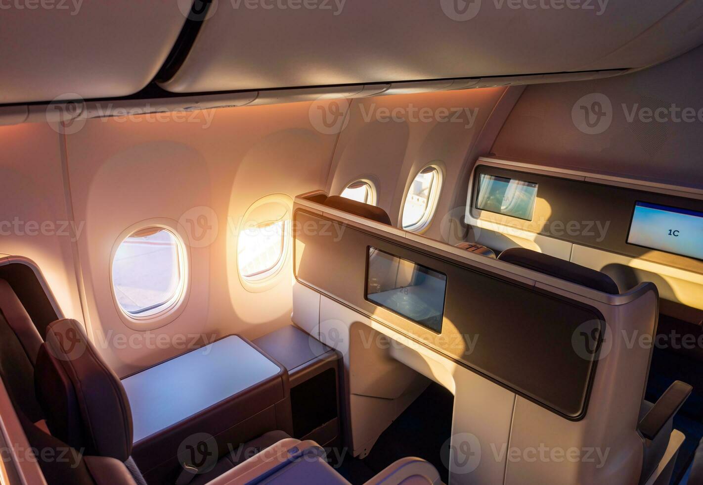 Modern airplane interiors, luxury first class and business class seats with entertainment area photo