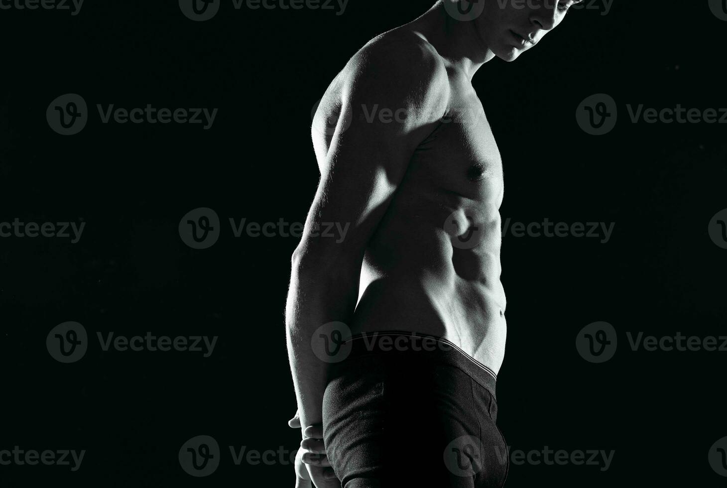 muscular man in black shorts gym black and white photo