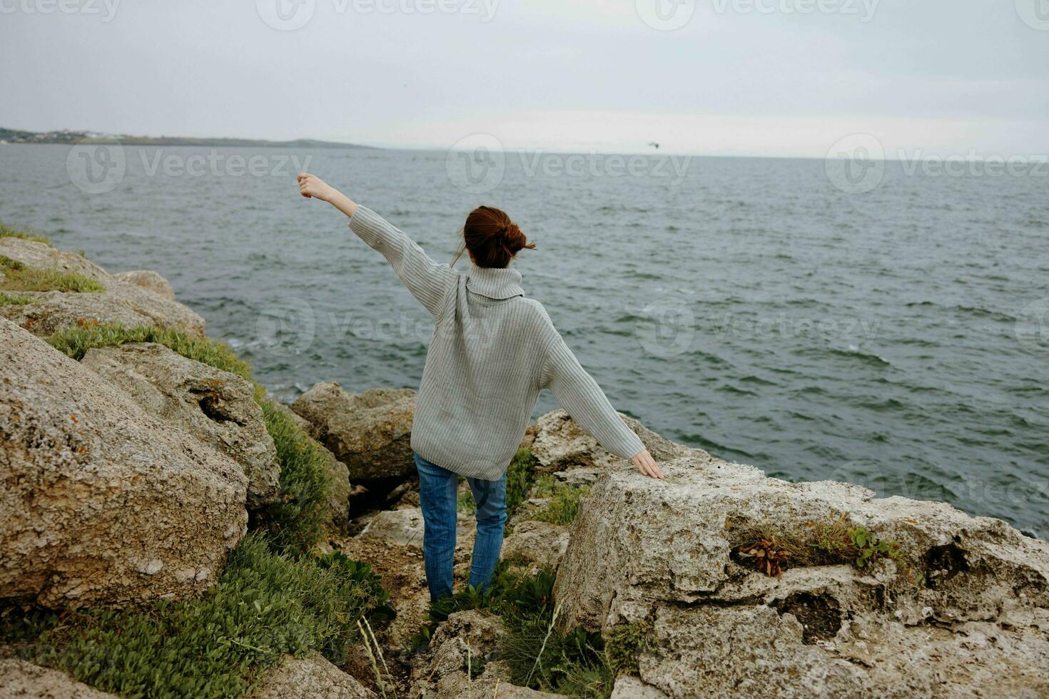 woman freedom walk on the stone coast Lifestyle photo