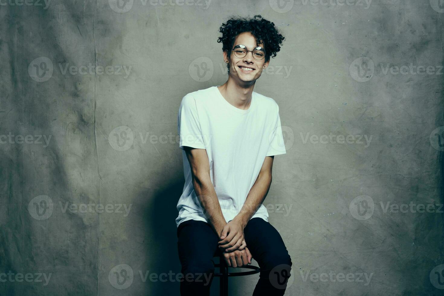 cute guy with curly hair in white t-shirt glasses fashion photo