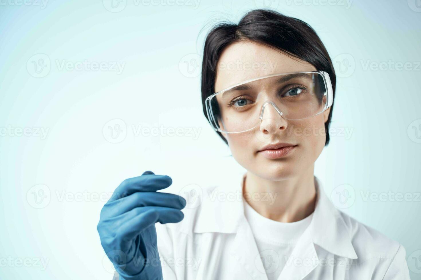 Woman laboratory assistants in white coat winter gloves research test biology photo