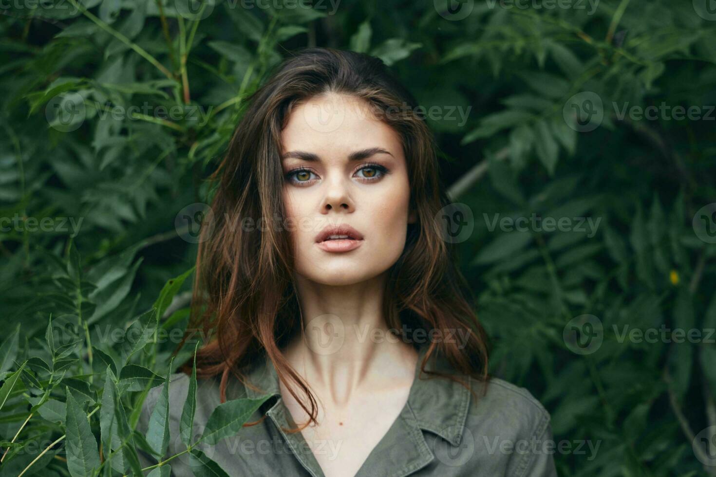 Portrait of a woman Close-up of a brunette in the forest nature travel photo