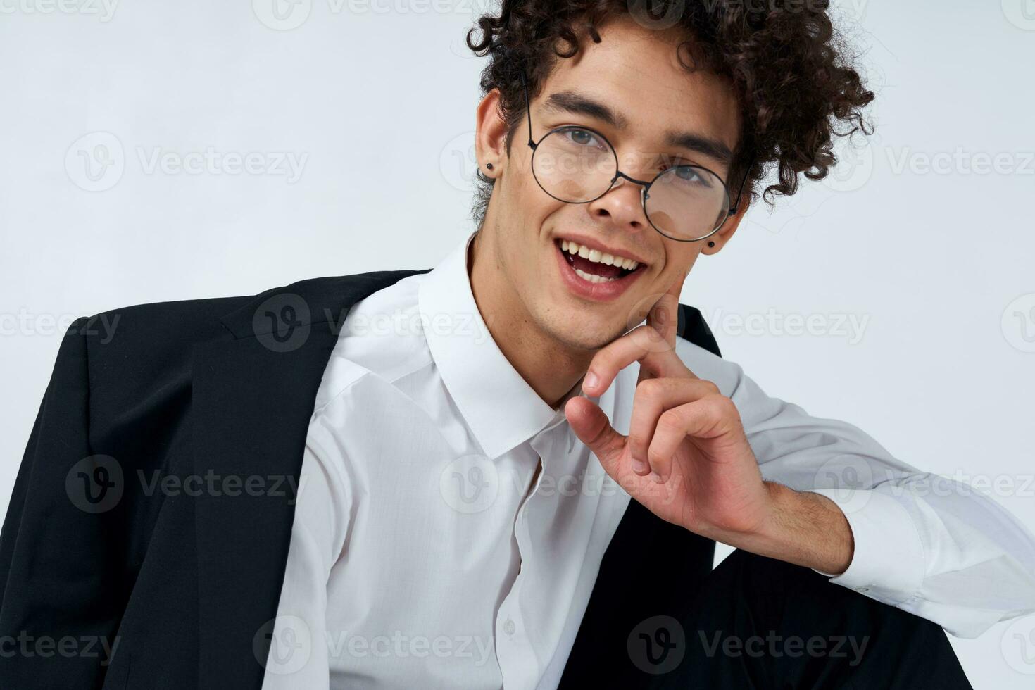 guy in glasses and in a classic suit on a light background portrait close-up photo