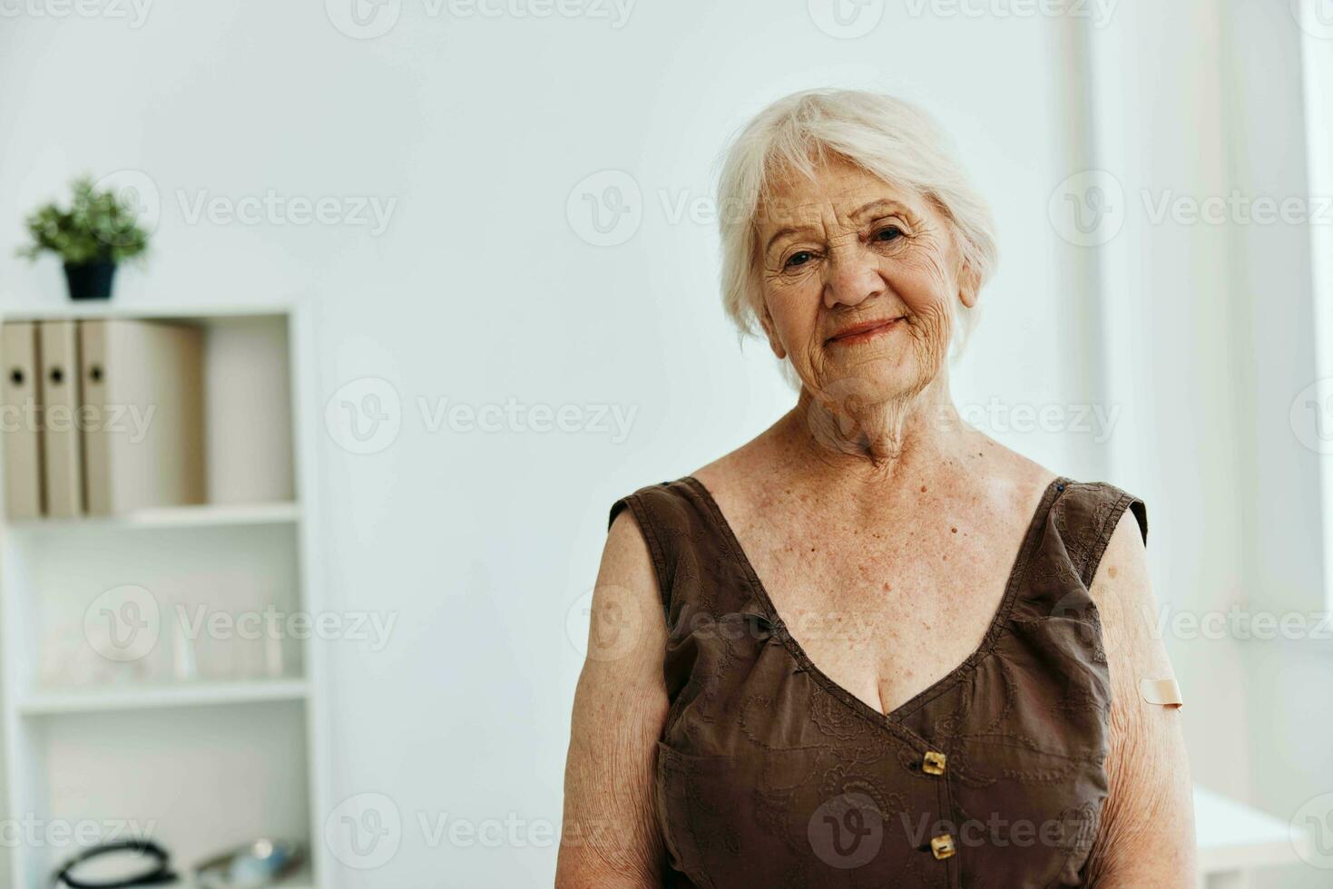 elderly woman with plaster on her arm covid passport immunization safety photo