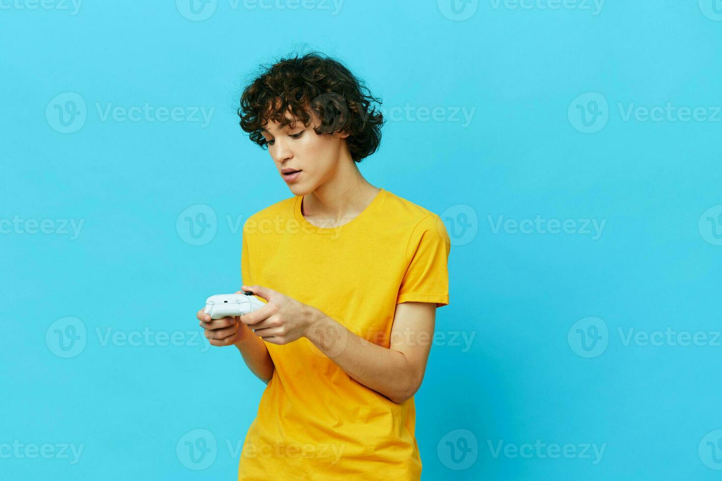 man plays with joystick in yellow t-shirts Lifestyle entertainment photo