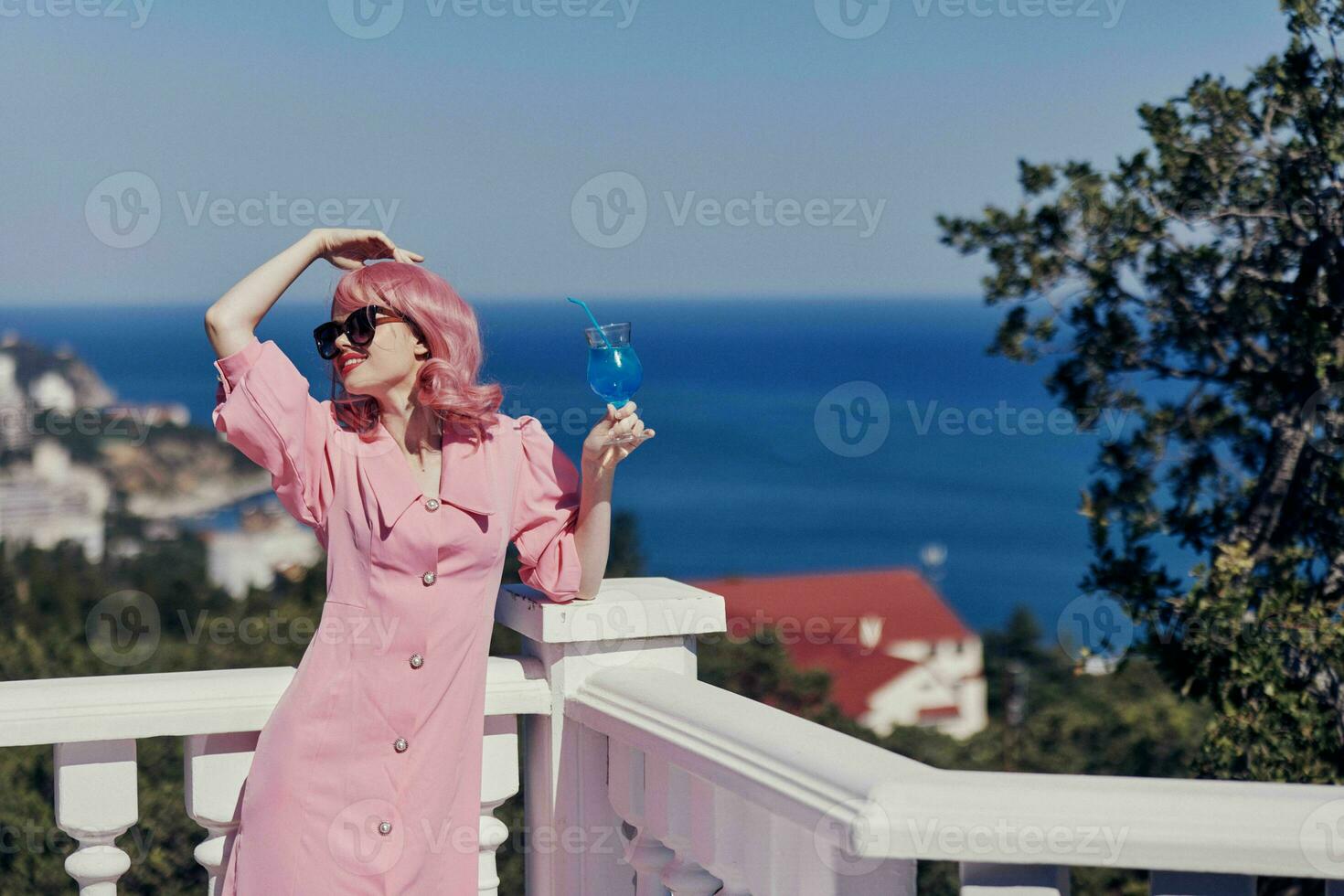 glamorous woman drinking a cocktail on the terrace Relaxation concept photo