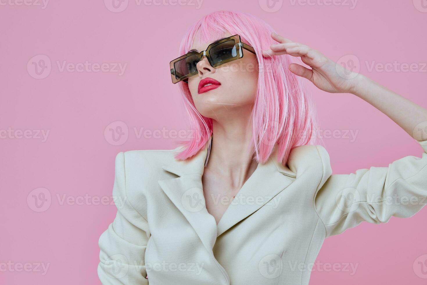 Portrait of a charming lady modern style pink hair sunglasses pink background unaltered photo