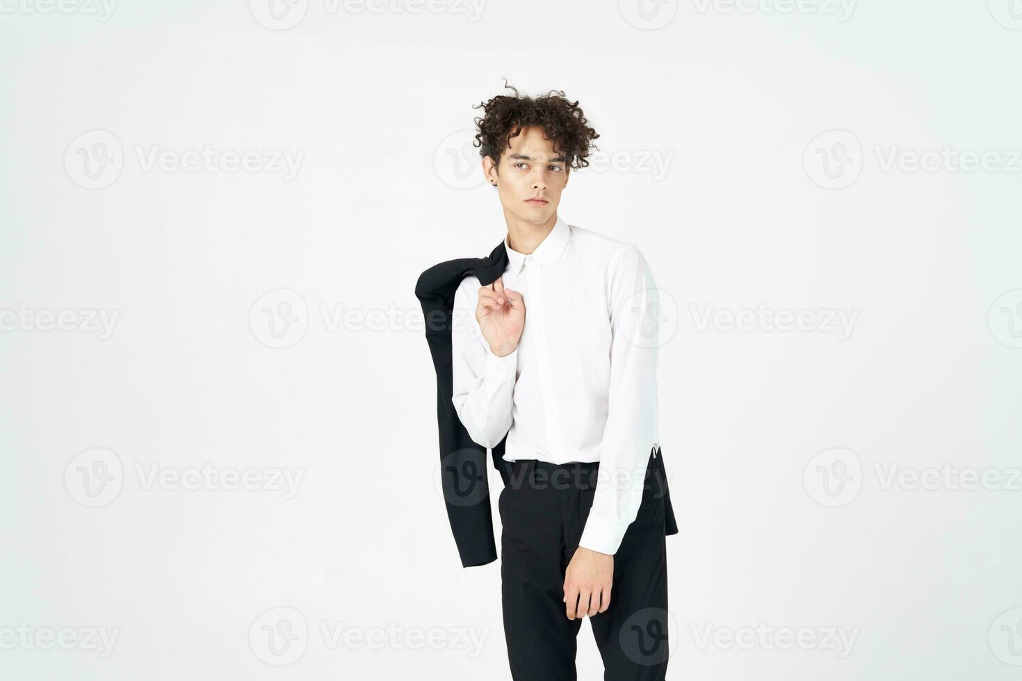 guy in a jacket shirt and trousers on a light background curly hair cropped view model photo