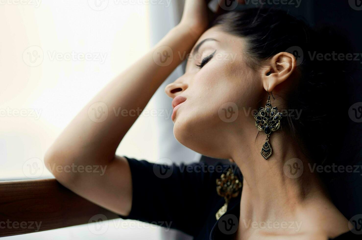 brunette holding a camera near the window decoration fashion lifestyle studio photo