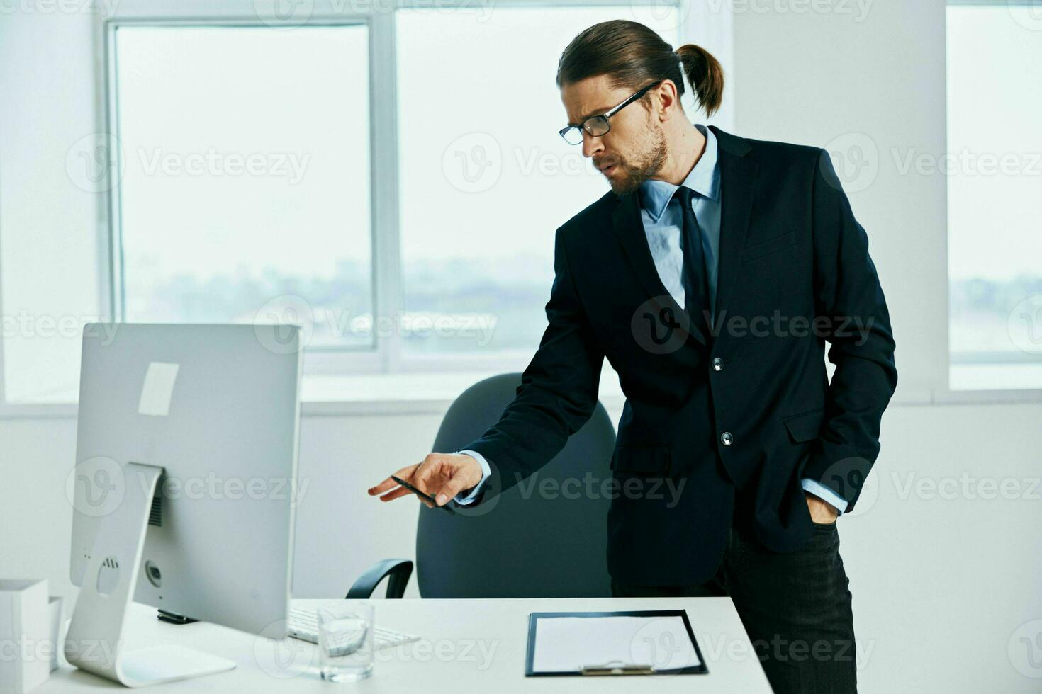 male manager in the office gestures with his hands computer photo