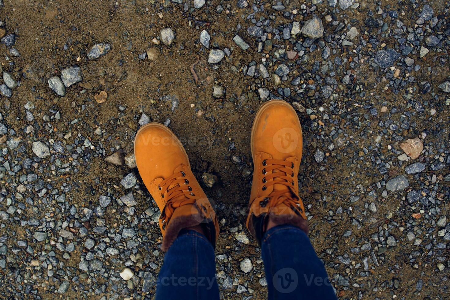 female feet in boots on the ground nature top view photo