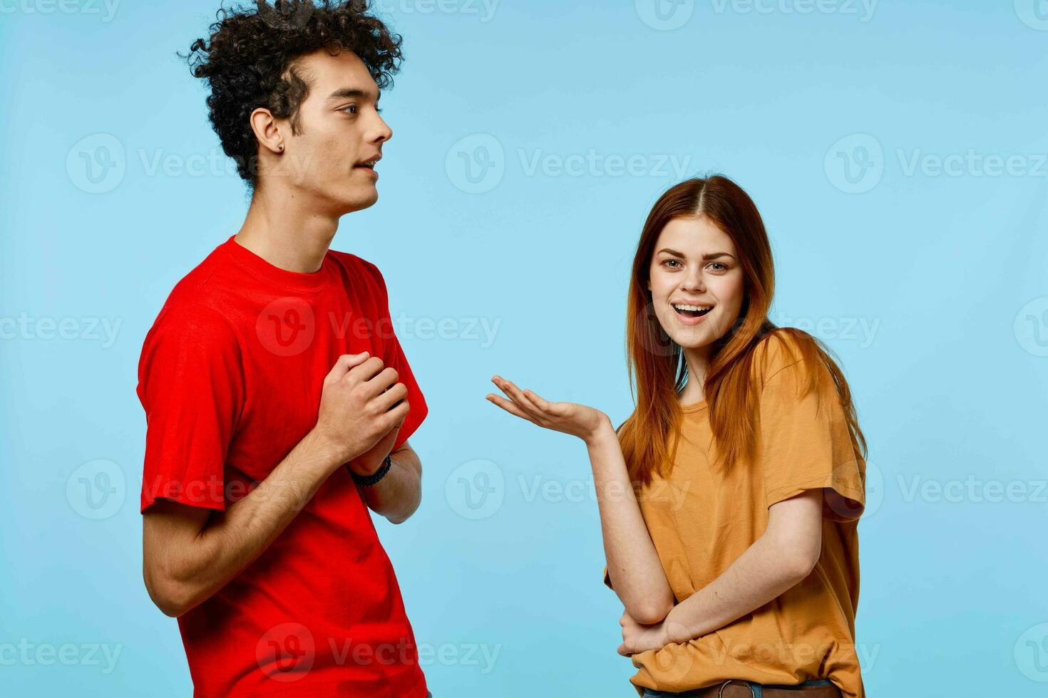 man and woman in colorful t-shirts communication youth style blue background photo