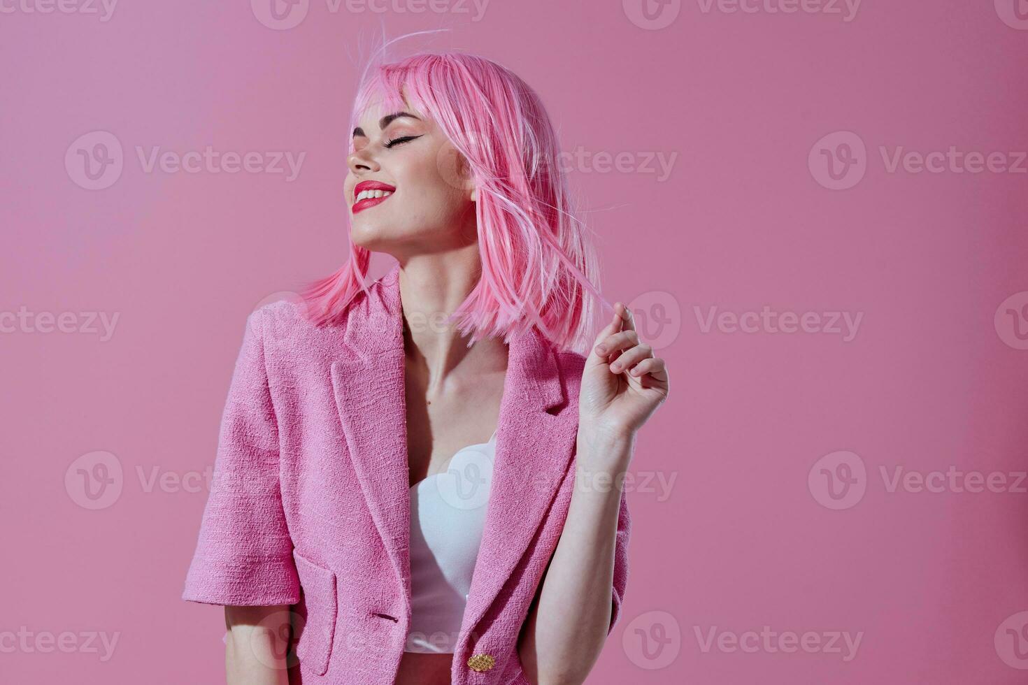 Portrait of a charming lady in a pink blazer pink wig cropped view pink background unaltered photo