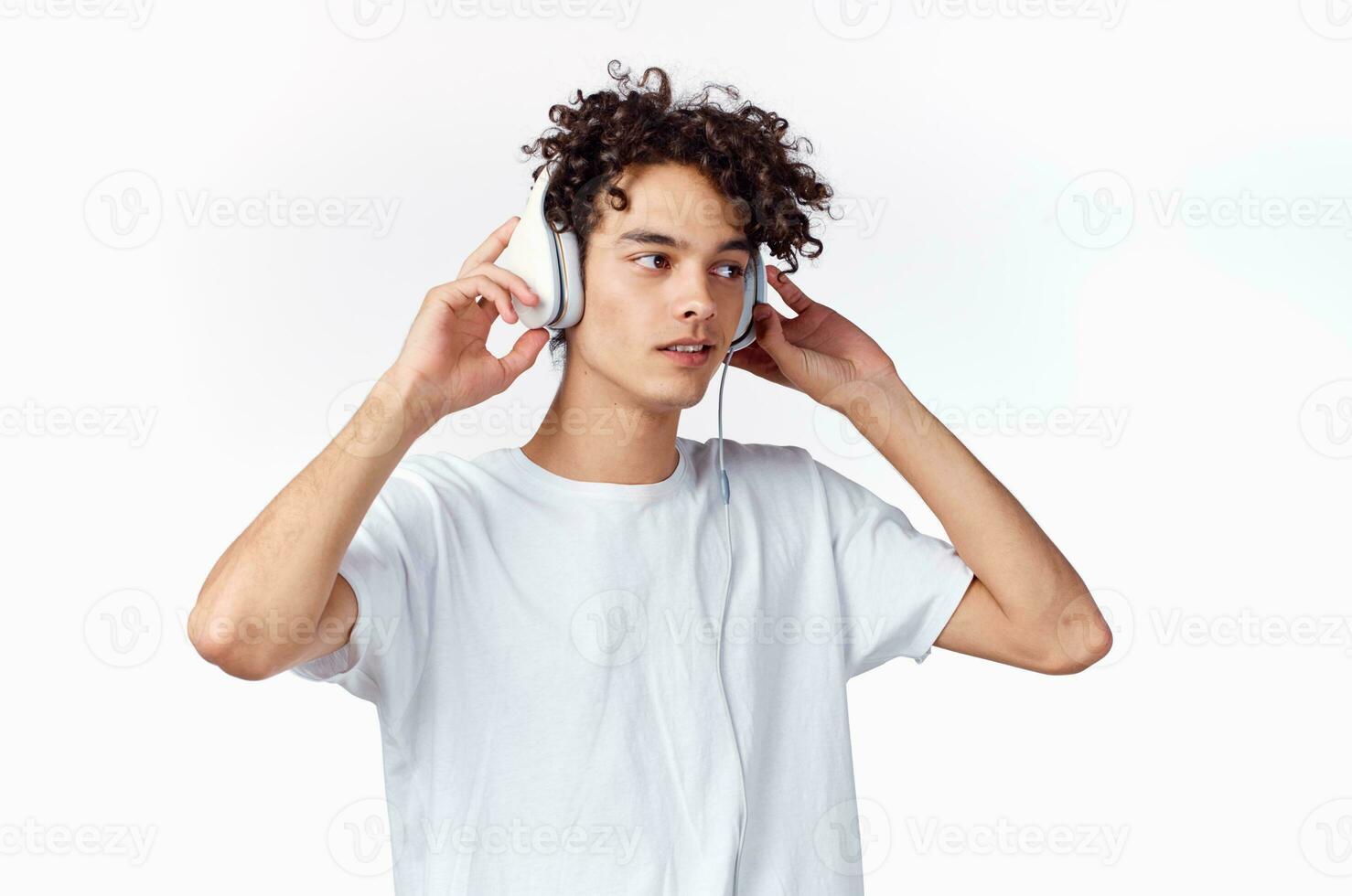 curly guy in headphones listens to music emotions entertainment photo