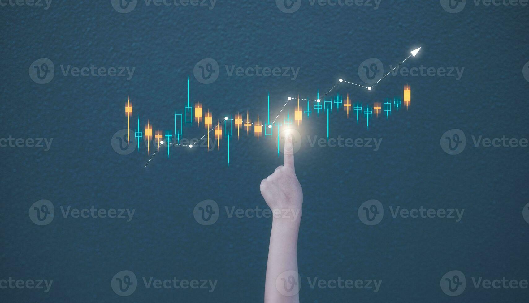 investment financial concept, kid girl hand pointing to virtual trading graph on blurred concrete wall background photo