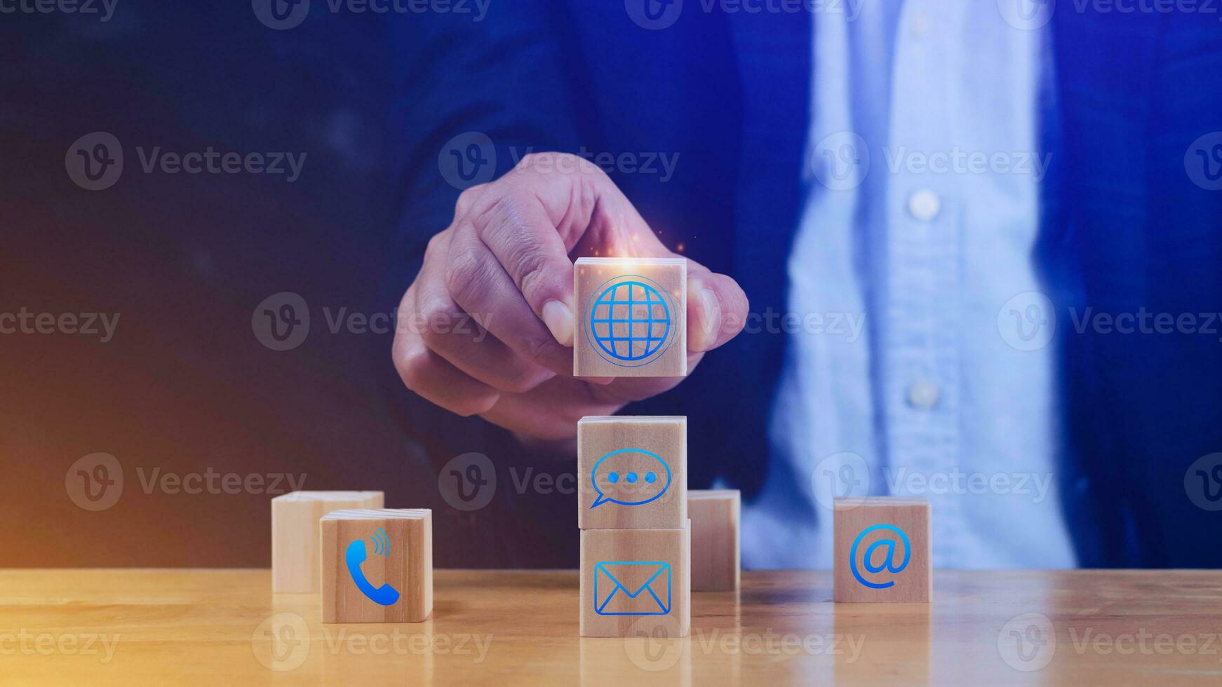 Businessman hand choose wooden block cube with symbol Global network connection, telephone, Chat, email, address, wifi, Website page contact us or email marketing concept. Digital link tech photo