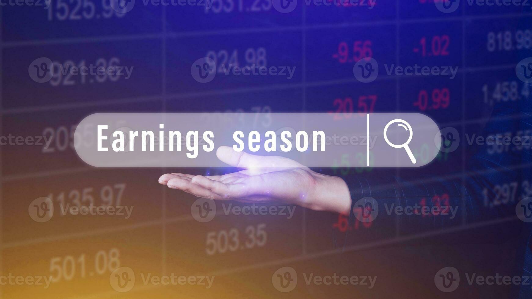 Earnings season, hand holding with written in search bar with the financial data visible on background, Reports Stock Market Ticker photo