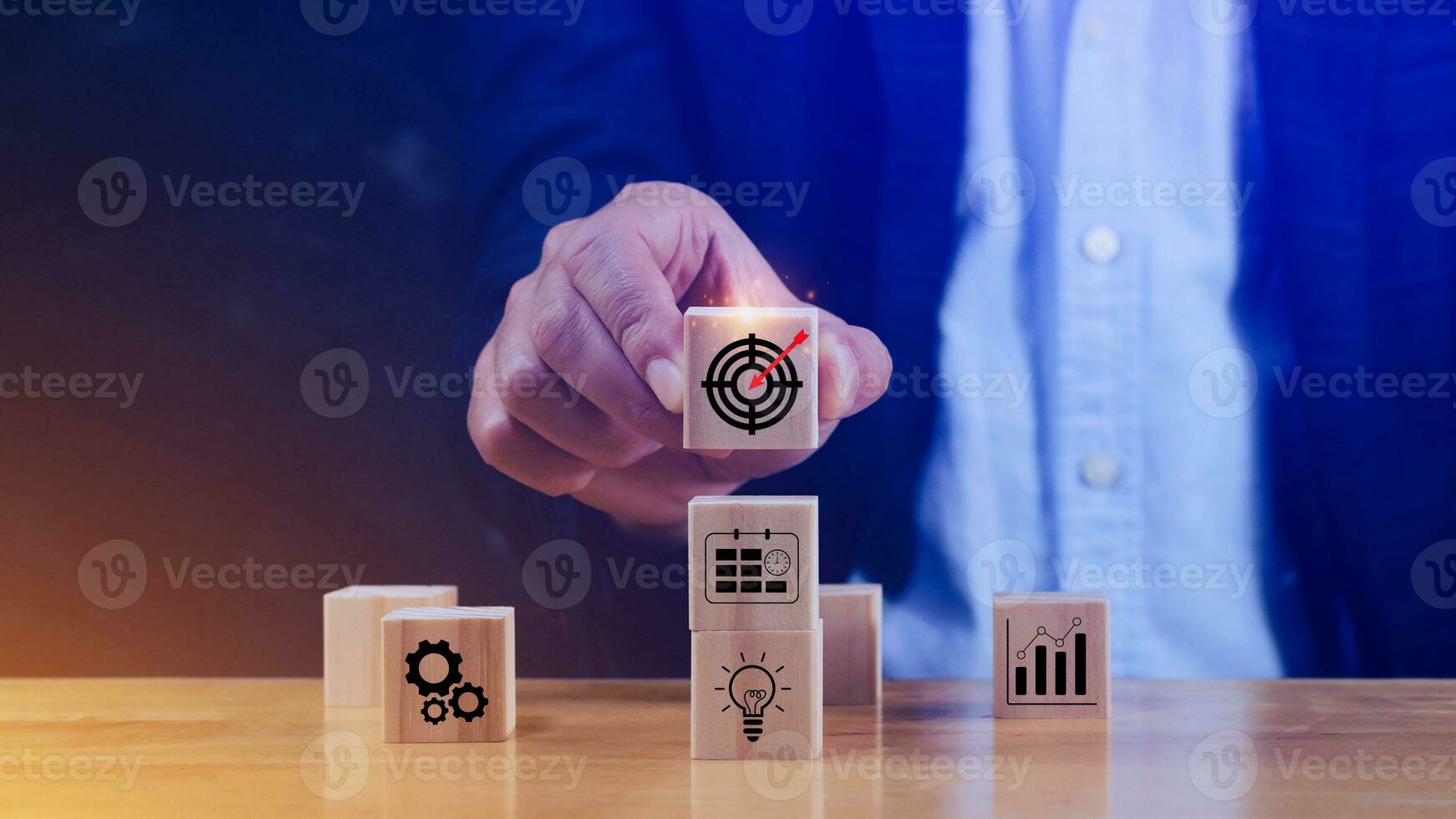 Concept of business planning strategy, Hand choose the wooden cube block with icon aiming goal icon Action plan, Success and business target concept, Company strategy development. photo