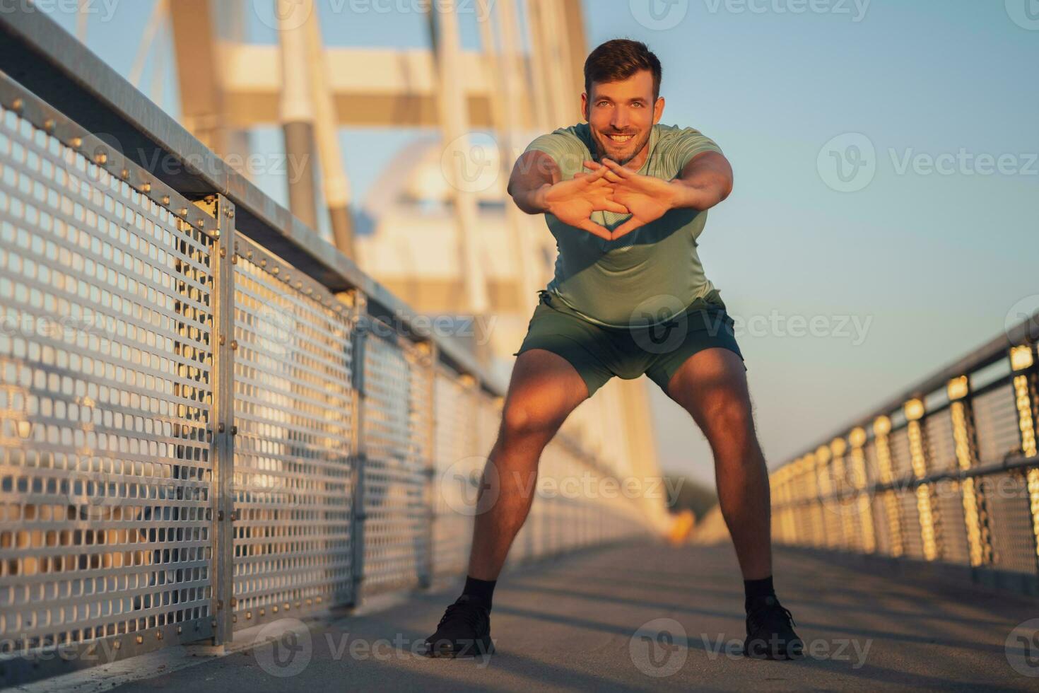 A man in a green t-shirt doing exercises photo