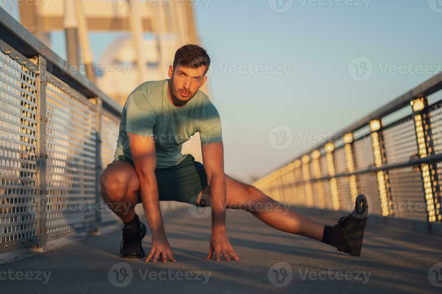 A man in a green t-shirt doing exercises photo
