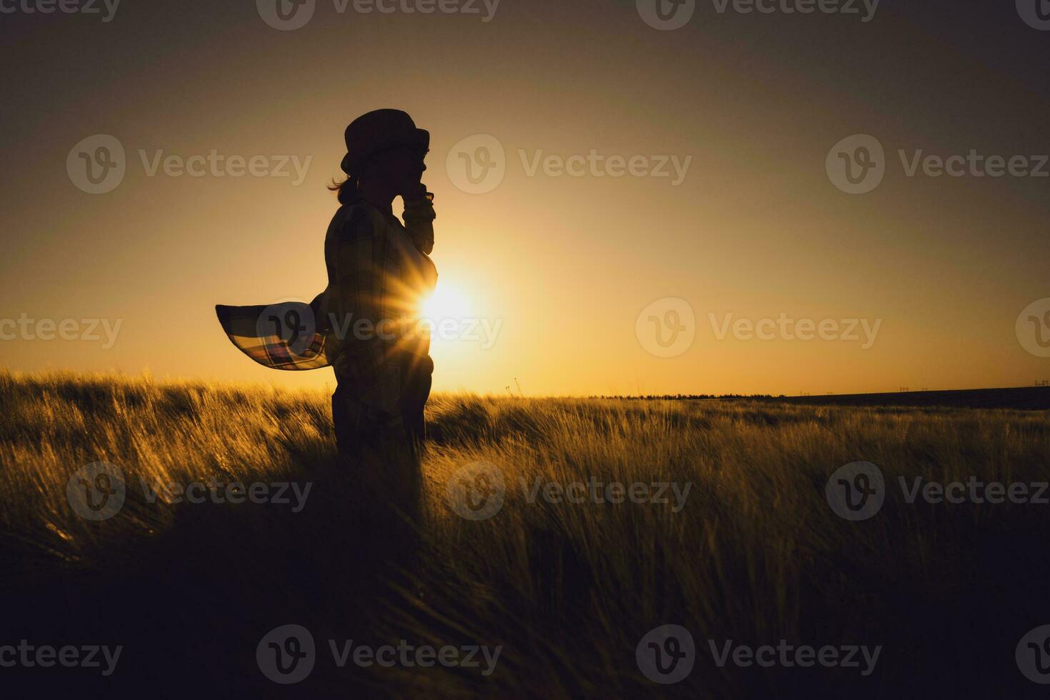 Farmer woman over the sunset photo