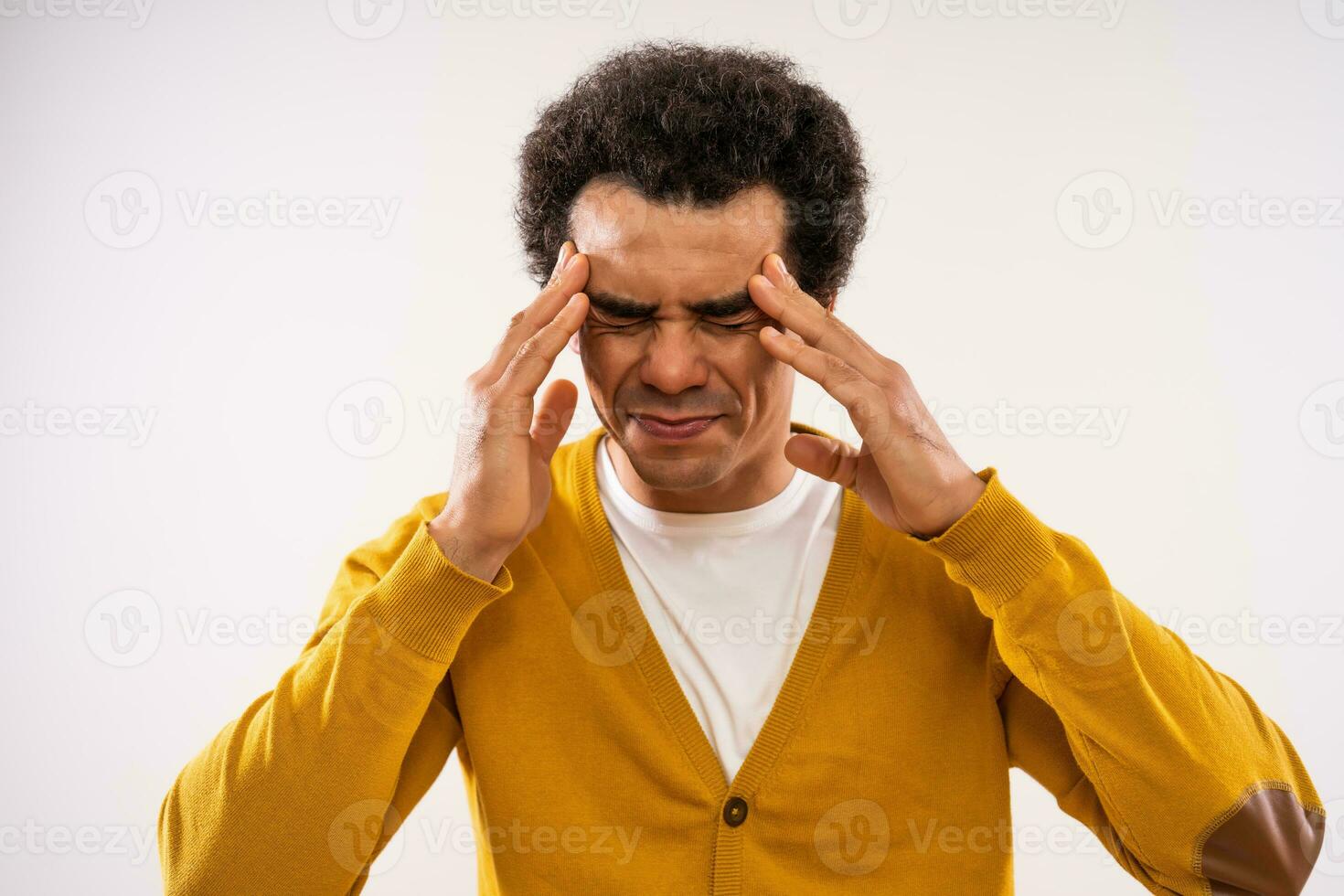 Studio shot portrait of multiracial man with a headache. photo
