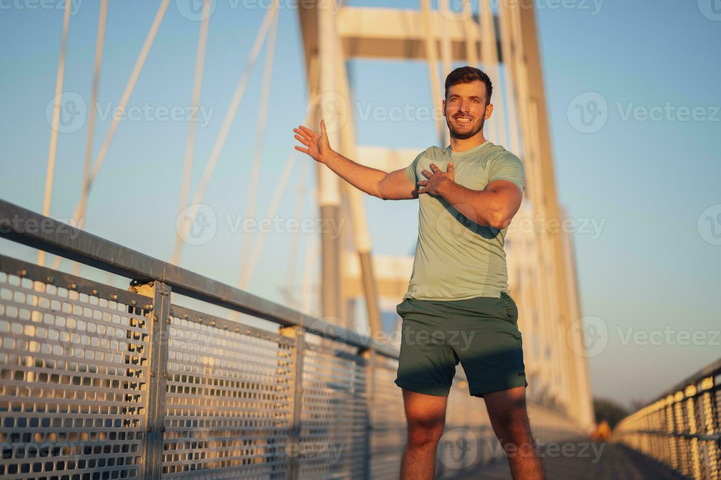 A man in a green t-shirt doing exercises photo