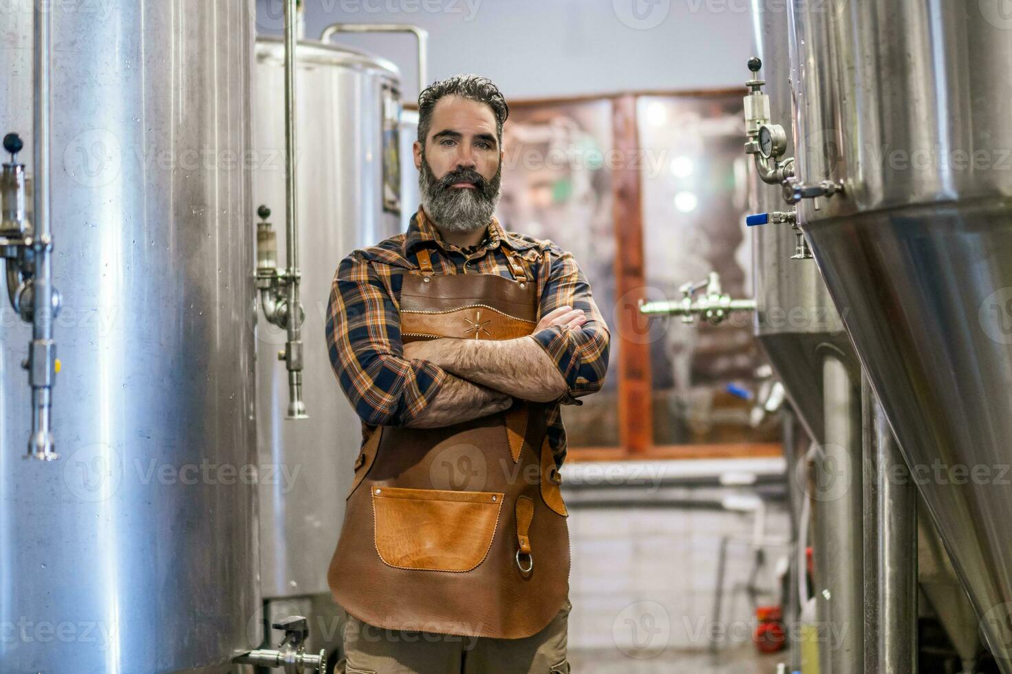 hombre es trabajando a arte cerveza fábrica. él es operando maquinaria en cervecería. pequeño familia negocio, producción de arte cerveza. foto