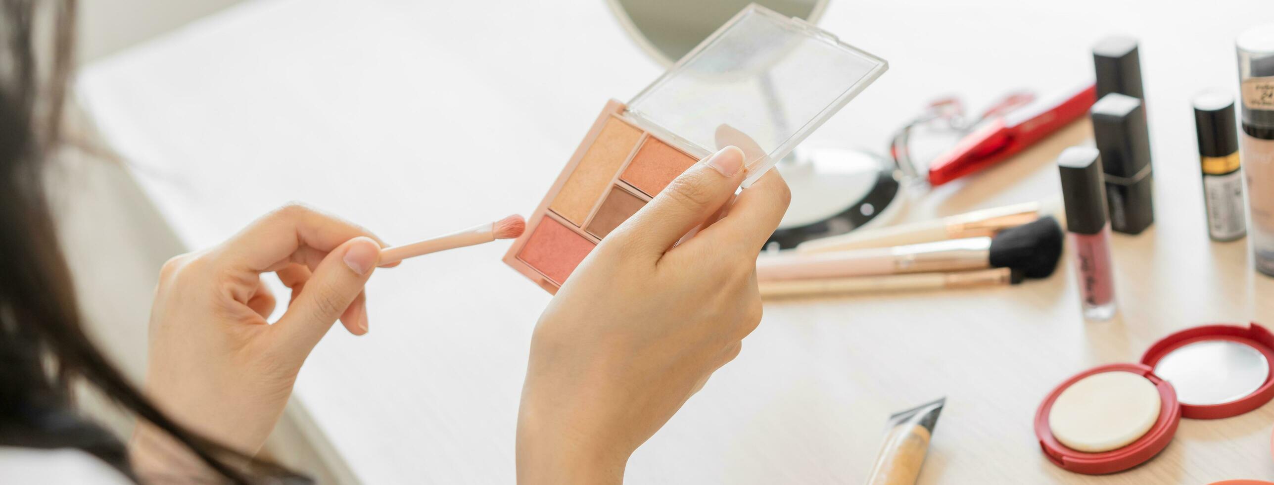 Happy beauty, beautiful asian young woman hand applying brush blush on powder case when makeup on face in routine, looking in mirror at home, look with natural fashion style, isolated on background. photo