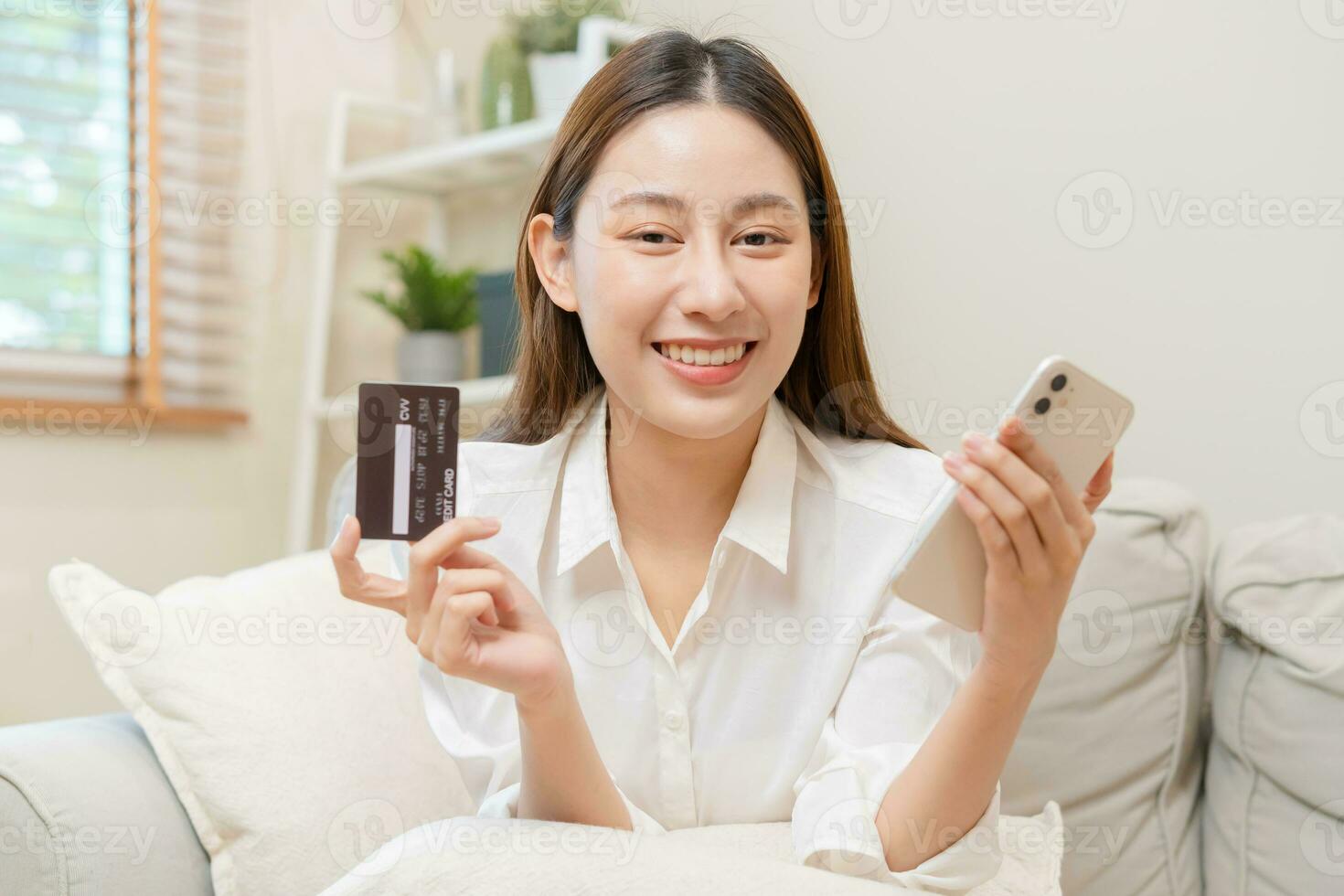 Online internet banking, asian young woman hand in payment spending by scan qr code, use phone, mobile to transfer money or pay money of credit card without cash at home. Technology of financial. photo