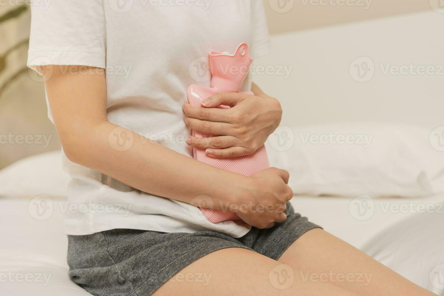 Menstruation, period cycle of monthly, hurt asian young woman, female hand in stomachache, suffer from premenstrual, belly or abdomen pain, using hot water bottle. Health problem Inflammation in body. photo