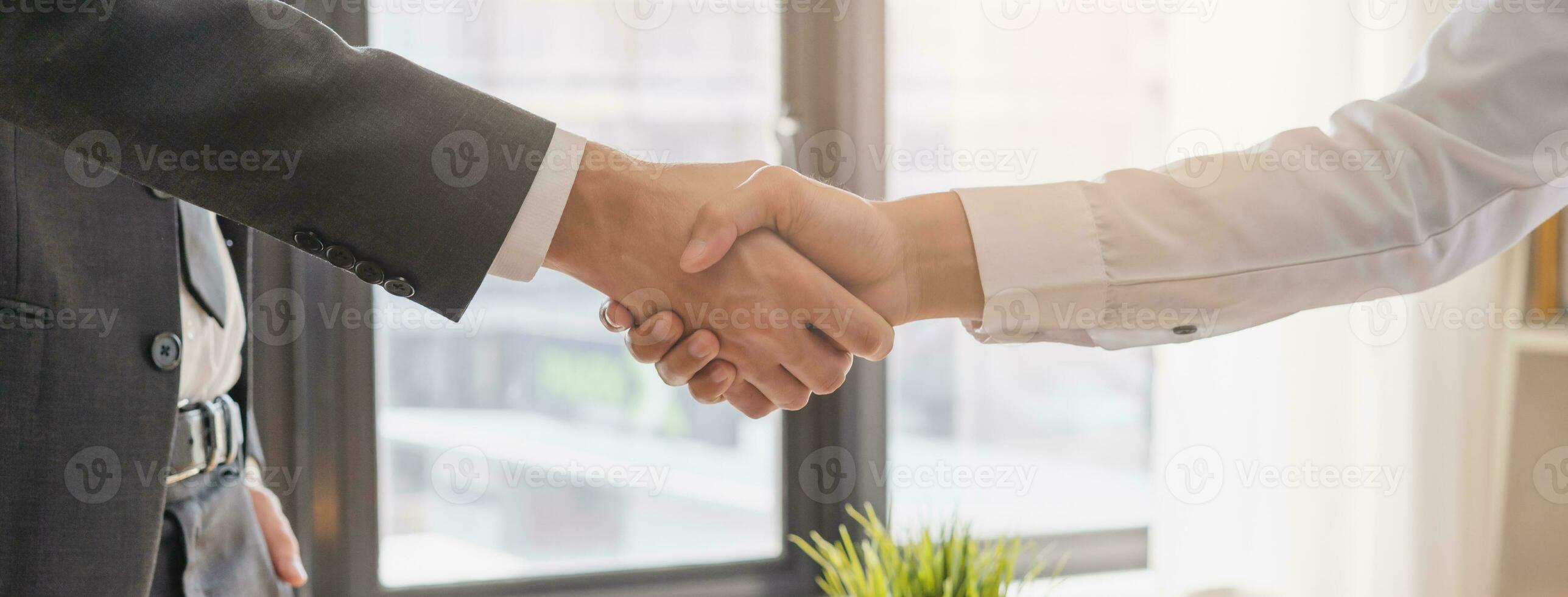 Successful asian young man, male partnership, teamwork handshake or greeting together at office after project done, good deal. Happy business people, worker or group meeting, shaking hands concept. photo