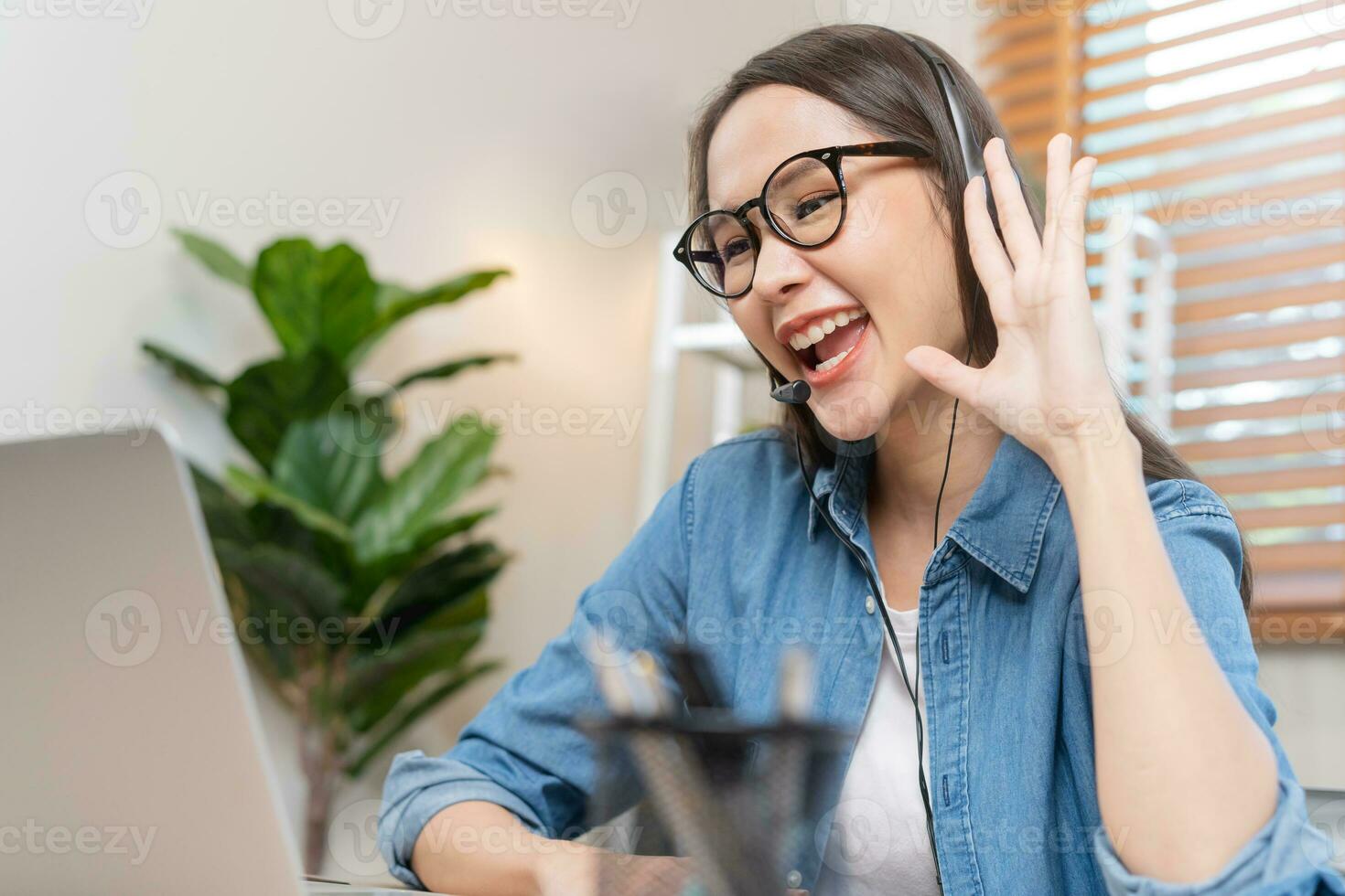 Video call, meeting conference, happy asian young woman, girl wearing eyeglasses study, learn online, using laptop computer or notebook via internet. Freelancer working from home, technology. photo