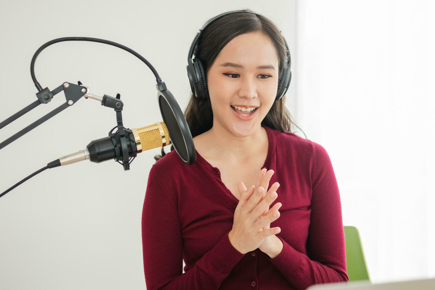 Beautiful asian young woman radio host working, setting microphone, preparing to speak before recording podcast and live on social media. Technology of on-air online in broadcasting at home studio. photo