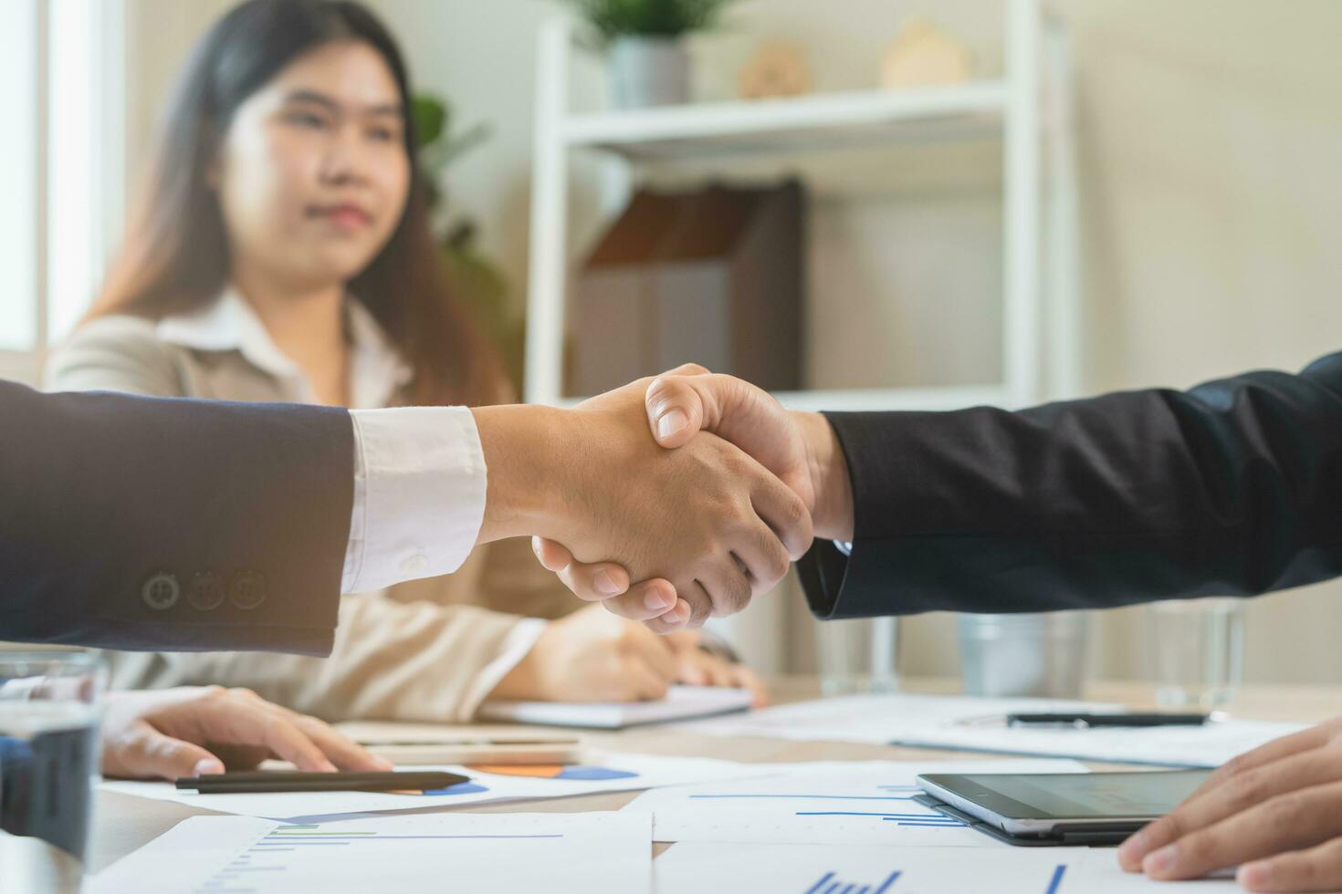 Congrats, business partnership people, asian happy young businessman handshake, shaking hands with partnership, customer or colleague after finishing successful meeting, good deal. People working. photo