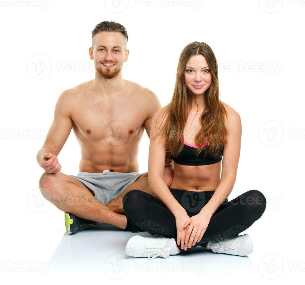 Sport couple - man and woman after fitness exercise on the white photo