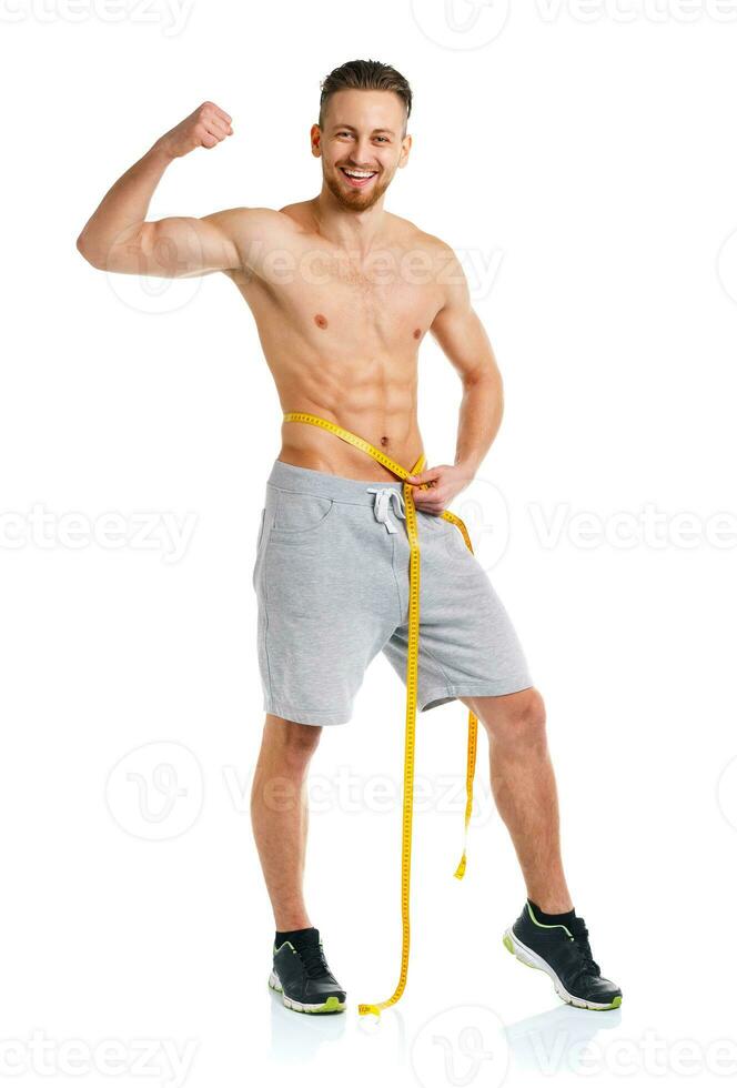 Athletic man with measuring tape on the white photo