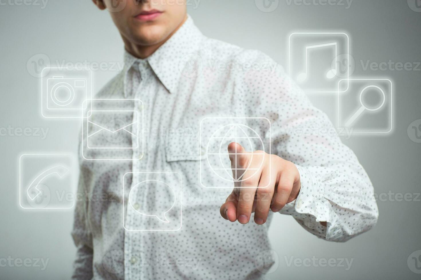 Young businessman pressing application button on computer with touch screen photo