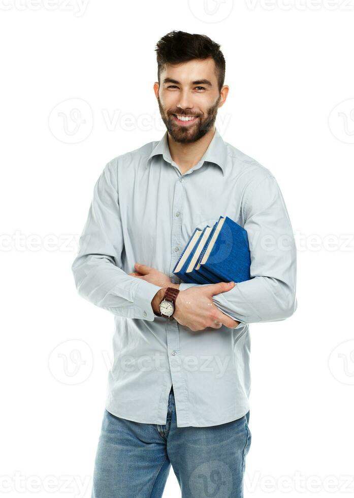 Young bearded smiling man with books in hands on white photo