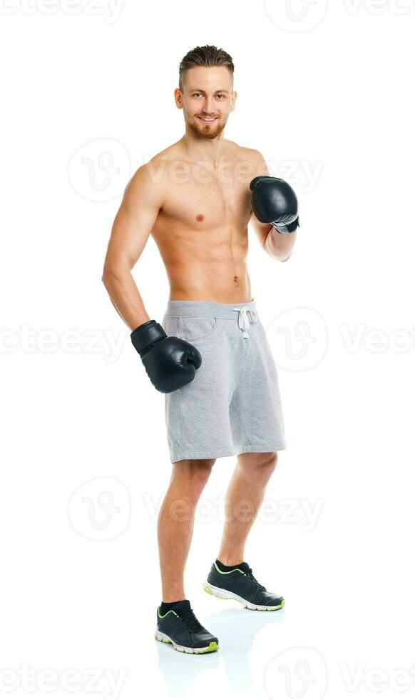 Athletic attractive man wearing boxing gloves on the white photo