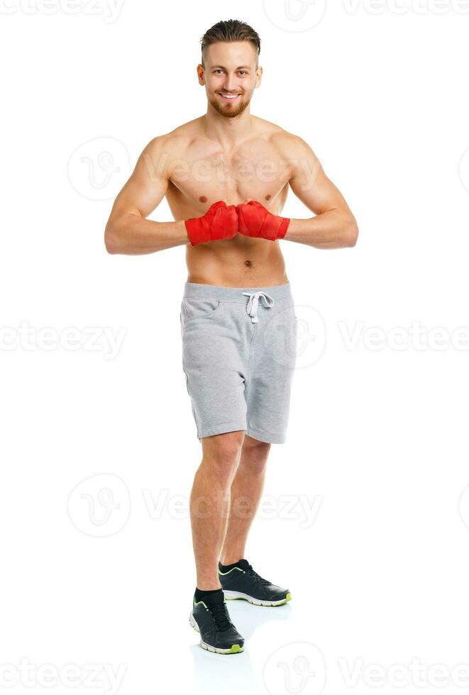 Athletic attractive man wearing boxing bandages on the white photo