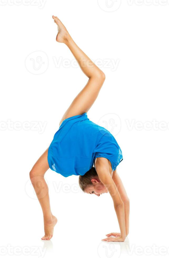 Young gymnast girl doing exercises photo