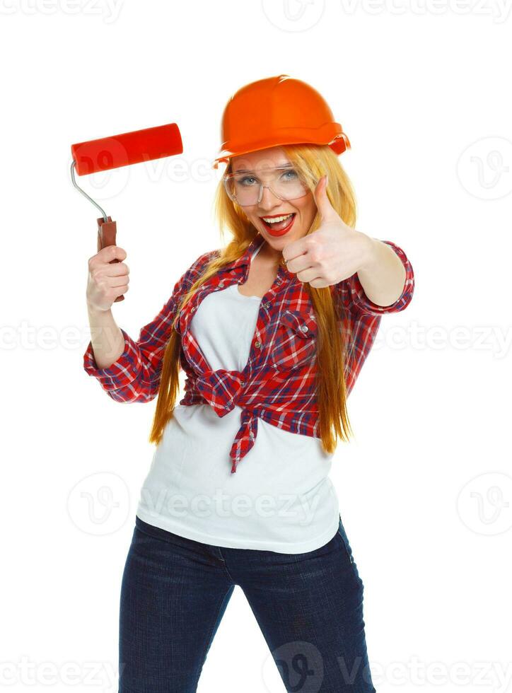 Funny girl in a helmet with roller in hand it is isolated on the white photo