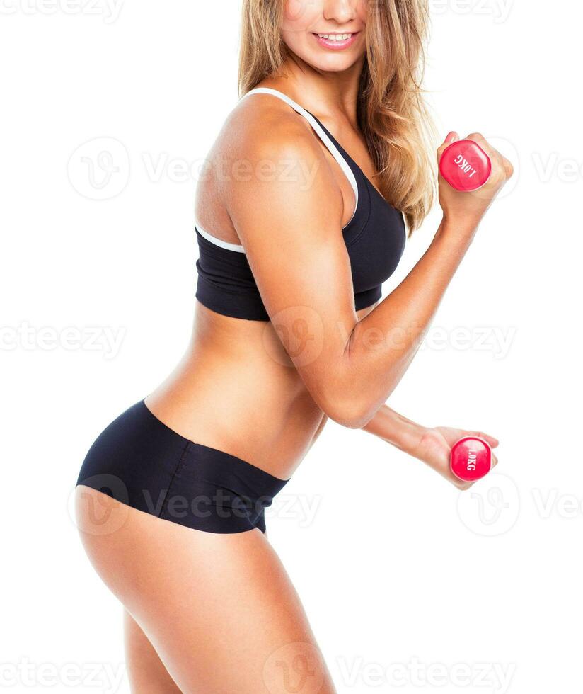 Beautiful slim woman with dumbbells, isolated on white photo