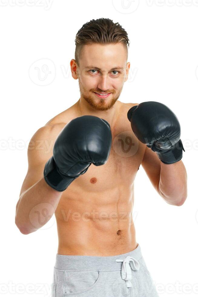 Athletic attractive man wearing boxing gloves on the white photo