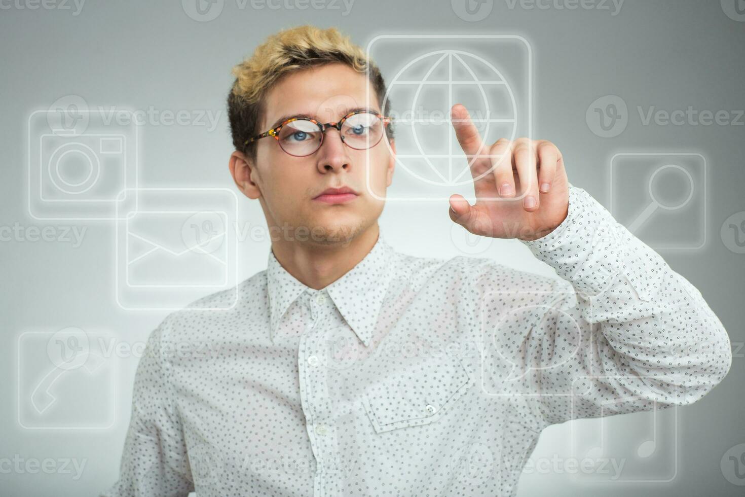 Young businessman pressing application button on computer with touch screen photo